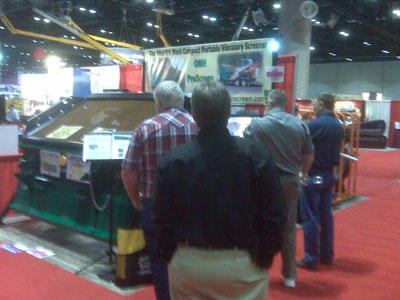 Visitors watch video at the OMH ProScreen USA Booth at the Rental Show, Feb 9, 2010, Orlando, Florida